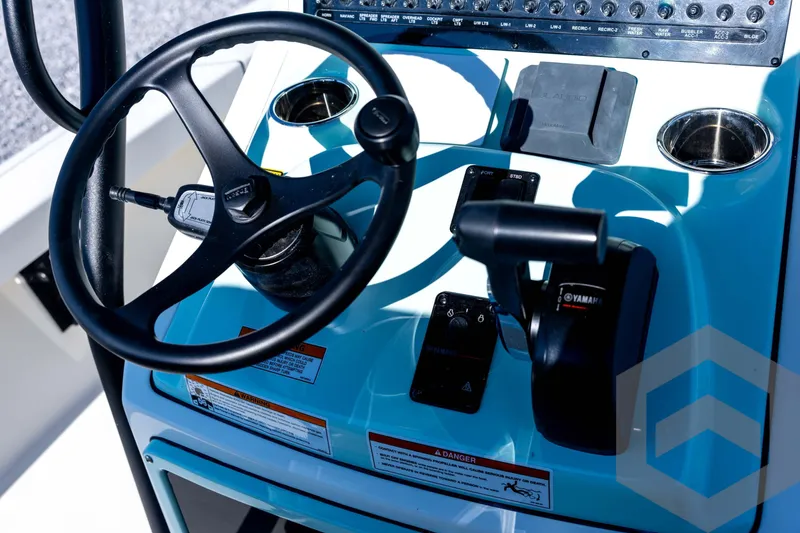 Slide: The Image of 2026 Pathfinder 2200 TRS boat console with steering wheel and controls. - 58