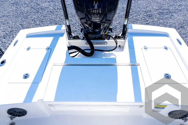 Slide: The Image of 2026 Pathfinder 2200 TRS boat deck with engine, storage compartments, and speakers. - 70