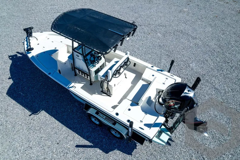 Slide: The Image of 2026 Pathfinder 2200 TRS boat with canopy and outboard motor on a trailer. - 79