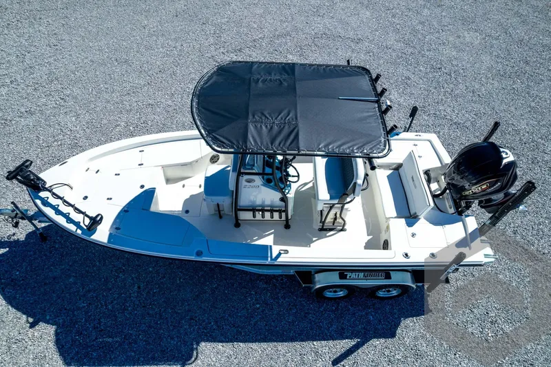 Slide: The Image of 2026 Pathfinder 2200 TRS boat with canopy, trailer, and outboard motor on gravel surface. - 80