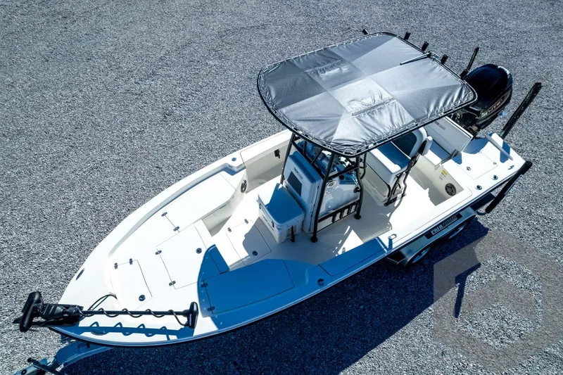 Slide: The Image of 2026 Pathfinder 2200 TRS boat with canopy, aerial view on gravel surface. - 81