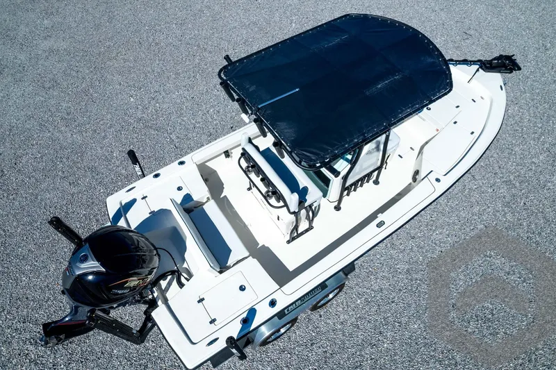 Slide: The Image of 2026 Pathfinder 2200 TRS boat with canopy, aerial view on gravel surface. - 85