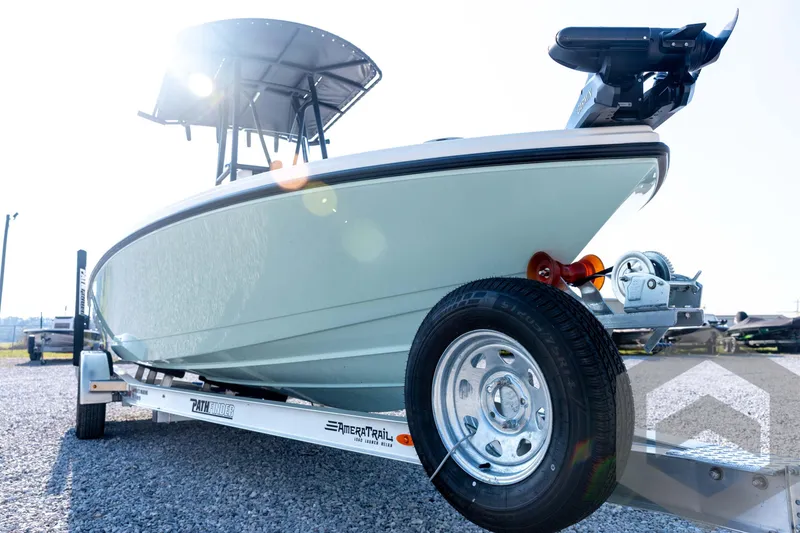 Slide: The Image of 2026 Pathfinder 2200 TRS boat on trailer, sunlit, showcasing sleek design and modern features. - 9