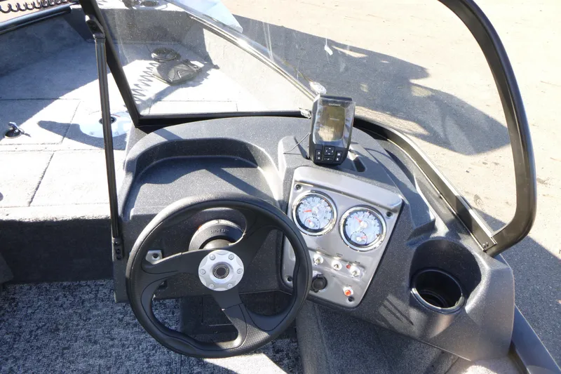 Slide: The Image of 2026 Tracker Pro Guide V-16 WT boat dashboard with steering wheel and gauges. - 11