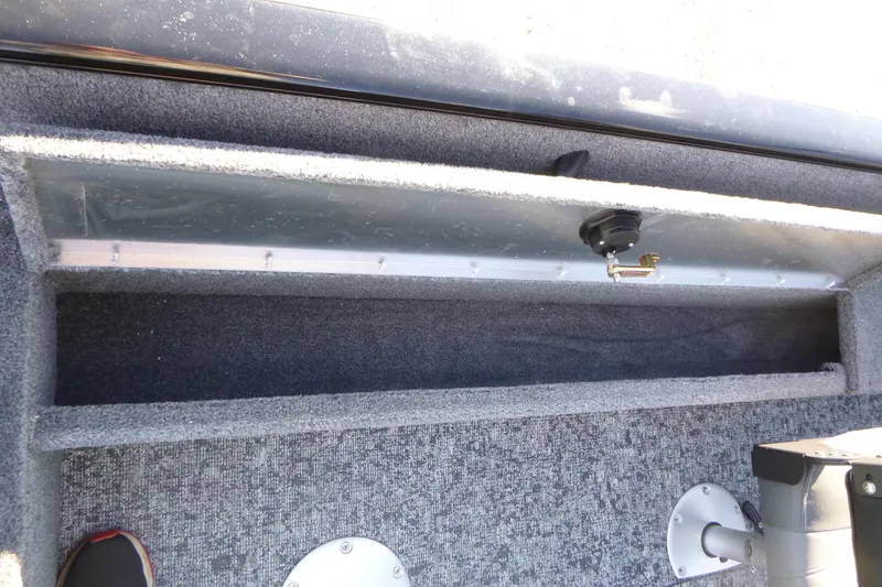 Slide: The Image of 2026 Tracker Pro Guide V-16 WT boat interior storage compartment with carpeted finish. - 13