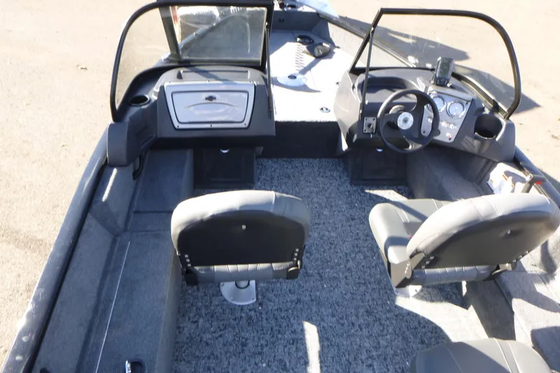 Slide: The Image of 2026 Tracker Pro Guide V-16 WT boat interior with dual seats and steering console. - 4