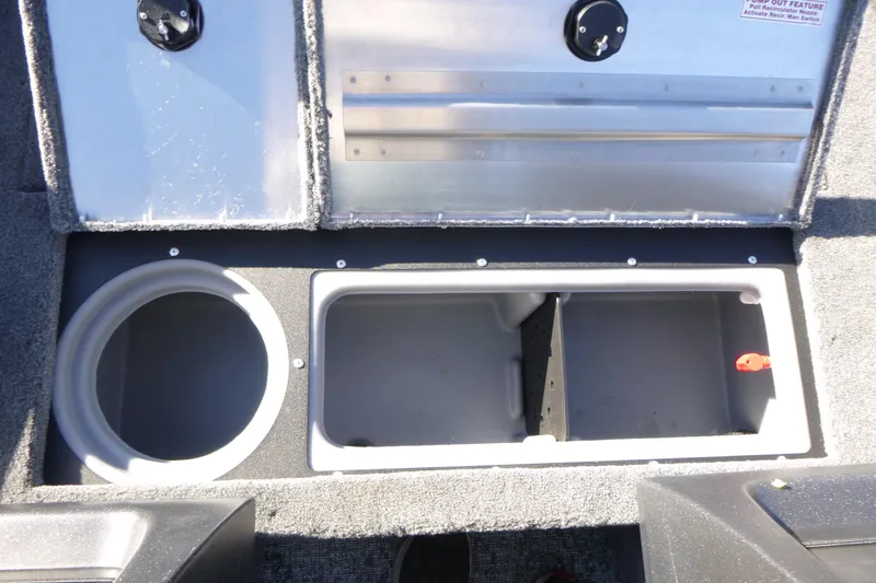 Slide: The Image of 2026 Tracker Pro Guide V-16 WT boat storage compartments with open lids. - 8