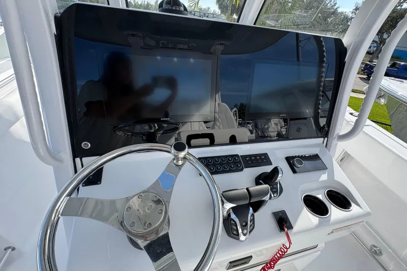 Slide: The Image of 2026 Sportsman Open 302 Center Console dashboard with steering wheel and modern controls. - 10