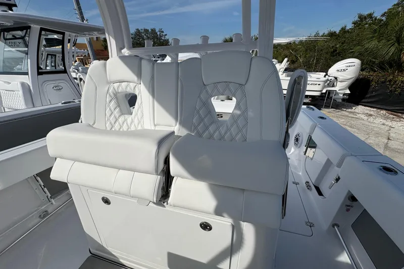 Slide: The Image of 2026 Sportsman Open 302 Center Console boat with luxurious white seating and modern design. - 11