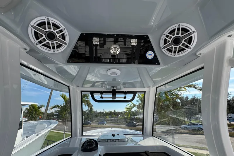 Slide: The Image of 2026 Sportsman Open 302 Center Console interior with speakers and panoramic windows. - 12