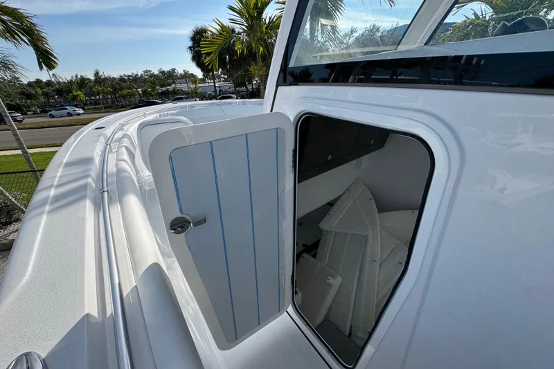 Slide: The Image of 2026 Sportsman Open 302 Center Console boat with open storage compartment. - 13