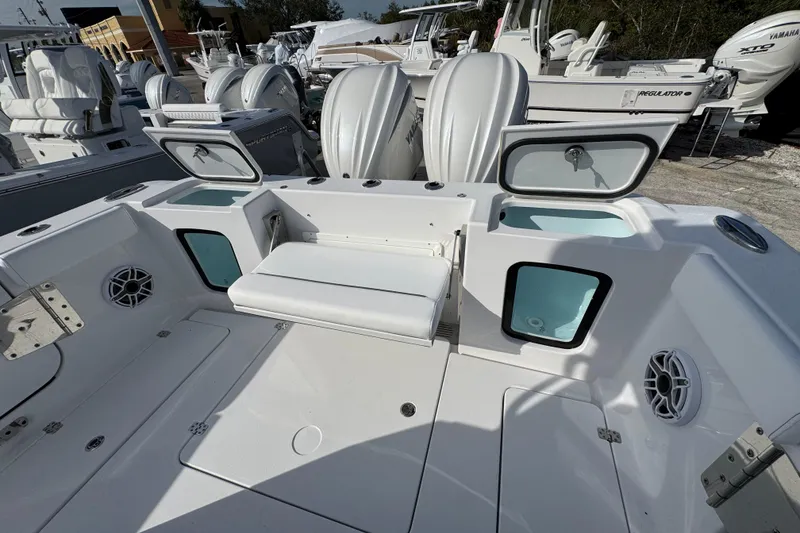 Slide: The Image of 2026 Sportsman Open 302 Center Console boat interior with seating and storage compartments. - 4