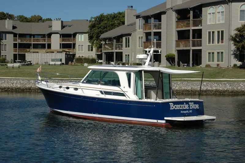 Slide: The Image of 2015 Back Cove 37 boat on water near residential buildings. - 10