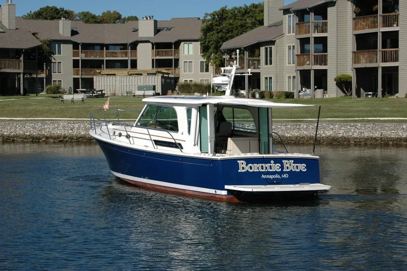 Slide: The Image of 2015 Back Cove 37 boat "Bonnie Blue" on water near residential buildings. - 11