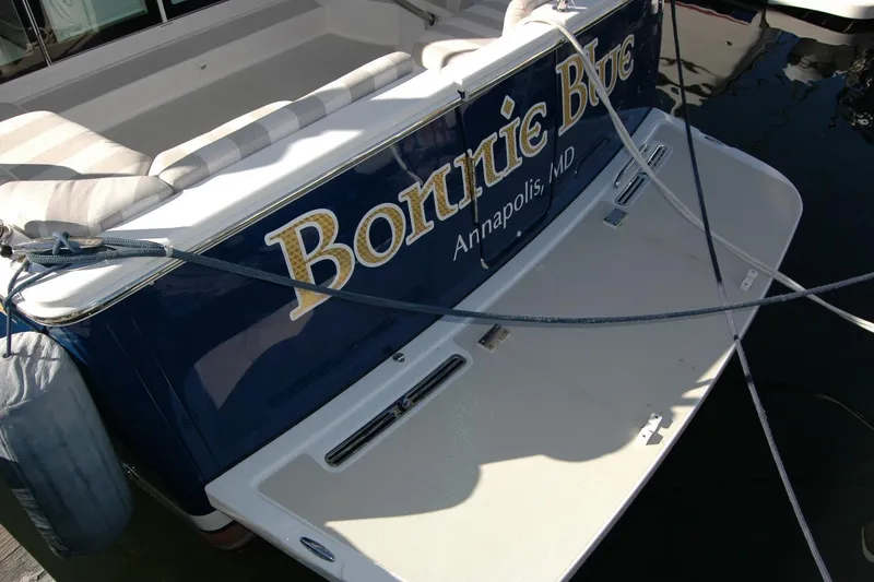 Slide: The Image of 2015 Back Cove 37 boat stern with name and location, docked in water. - 14