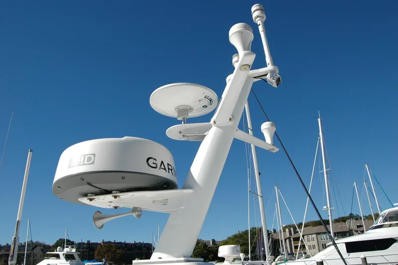 Slide: The Image of Radar and communication equipment on a 2015 Back Cove 37 boat under clear blue sky. - 15