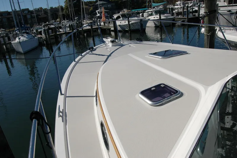 Slide: The Image of 2015 Back Cove 37 yacht deck, docked in a marina with other boats. - 19