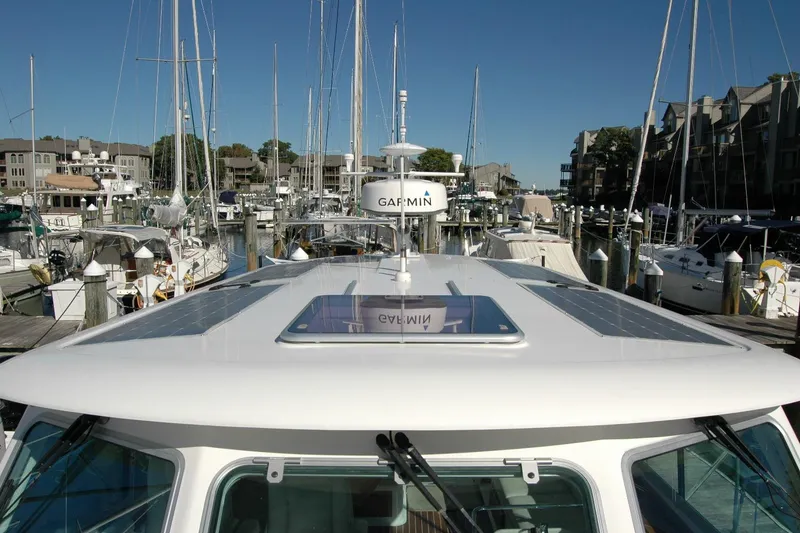 Slide: The Image of 2015 Back Cove 37 yacht docked in a marina, featuring Garmin equipment. - 20