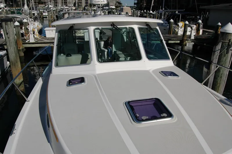 Slide: The Image of 2015 Back Cove 37 yacht docked at marina, showcasing sleek design and spacious deck. - 22