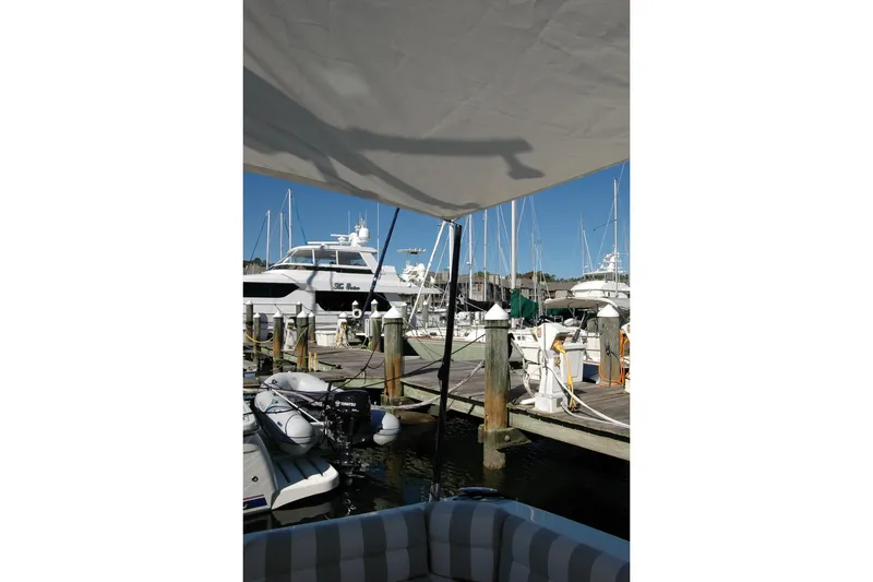 Slide: The Image of 2015 Back Cove 37 docked at marina with other boats under clear blue sky. - 33