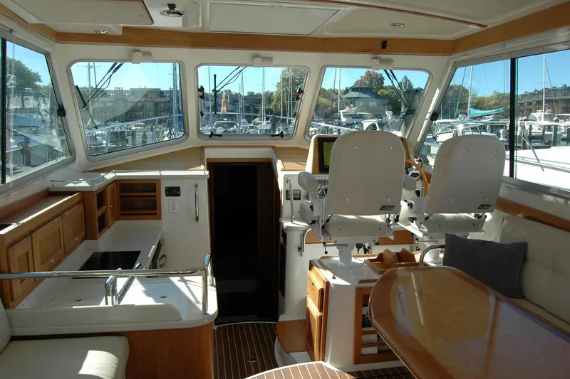 Slide: The Image of Interior of 2015 Back Cove 37 yacht with helm, seating, and kitchen area. - 34