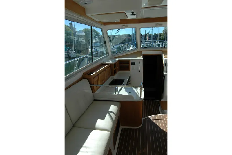 Slide: The Image of Interior of 2015 Back Cove 37 yacht with seating and windows overlooking marina. - 35