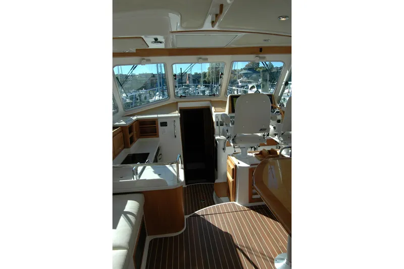Slide: The Image of Interior of 2015 Back Cove 37 yacht with helm, seating, and wooden flooring. - 36