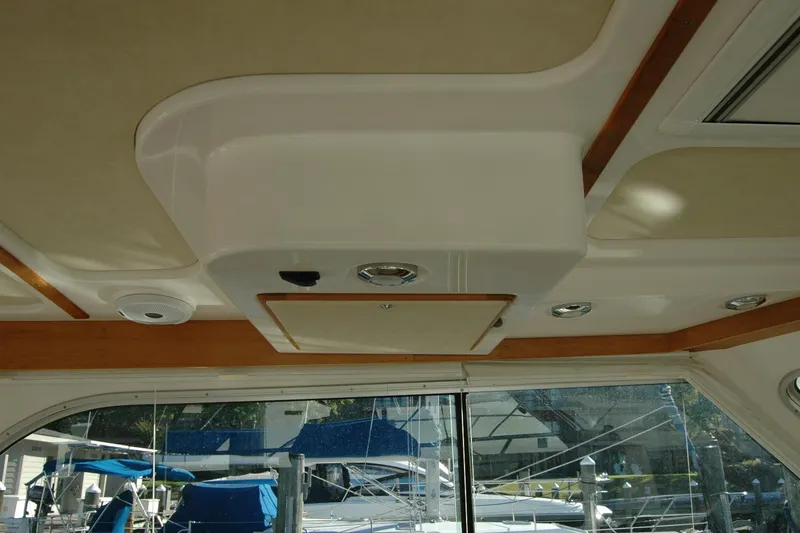 Slide: The Image of Interior ceiling of a 2015 Back Cove 37 boat with wood accents and lighting fixtures. - 45