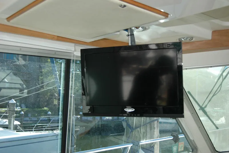 Slide: The Image of Flat-screen TV inside 2015 Back Cove 37 boat, near large windows. - 47