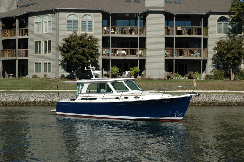 Slide: The Image of 2015 Back Cove 37 boat on water near residential building. - 5