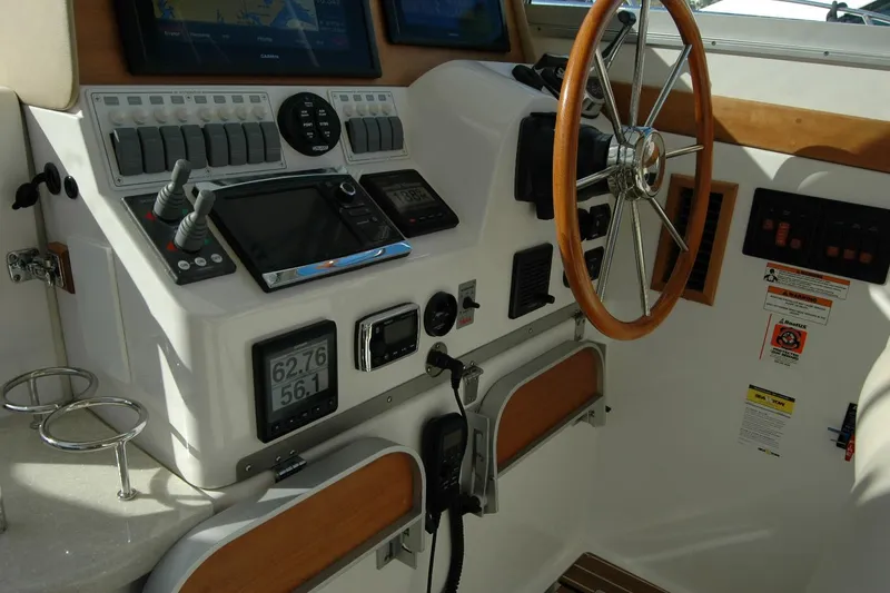 Slide: The Image of Helm of 2015 Back Cove 37 boat with navigation controls and steering wheel. - 50
