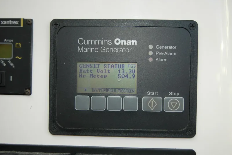 Slide: The Image of Cummins Onan marine generator display on 2015 Back Cove 37, showing battery voltage and hour meter. - 56