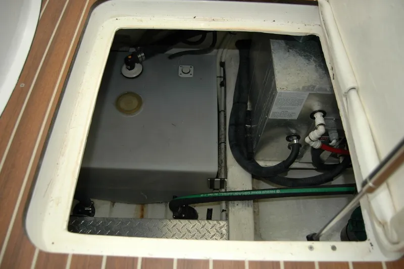 Slide: The Image of 2015 Back Cove 37 engine compartment with visible fuel tank and hoses. - 64