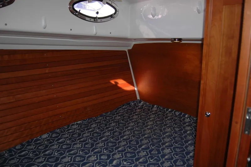 Slide: The Image of 2015 Back Cove 37 cabin interior with wood paneling and patterned bedding. - 69
