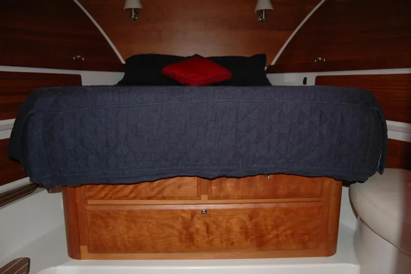 Slide: The Image of 2015 Back Cove 37 cabin interior with wooden storage and cozy bedding. - 75