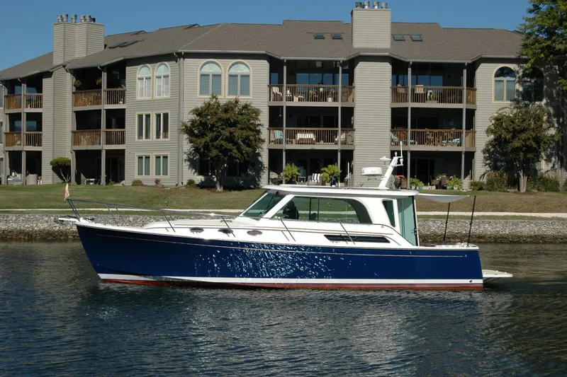 Slide: The Image of 2015 Back Cove 37 boat on water near waterfront apartments. - 8