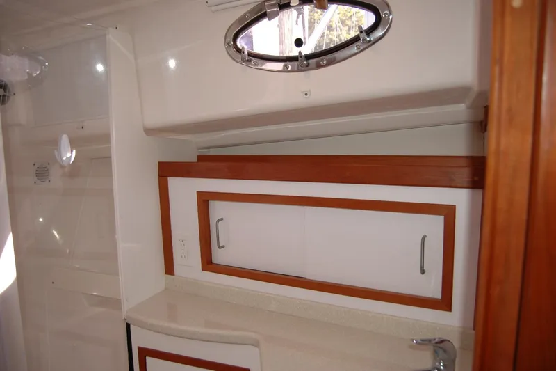Slide: The Image of 2015 Back Cove 37 yacht interior with wooden cabinetry and porthole window. - 84