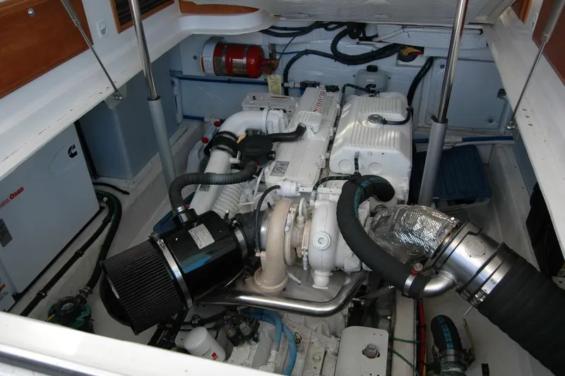 Slide: The Image of Engine compartment of a 2015 Back Cove 37 boat, showcasing mechanical components. - 85