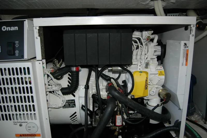 Slide: The Image of Engine compartment of a 2015 Back Cove 37 boat featuring an Onan generator. - 90