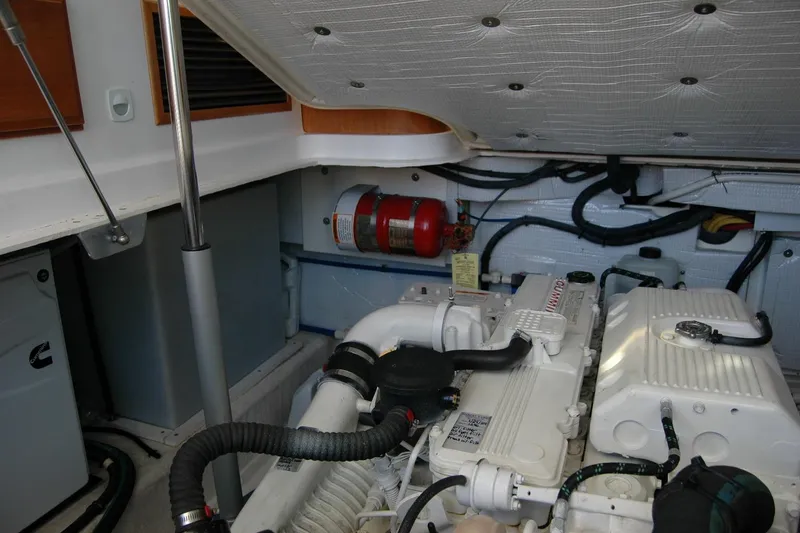 Slide: The Image of Engine room of 2015 Back Cove 37 boat with visible fire extinguisher and Cummins engine. - 91