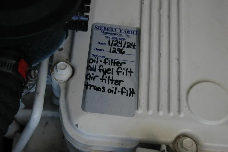 Slide: The Image of Maintenance label on a 2015 Back Cove 37 engine, listing filter services. - 93