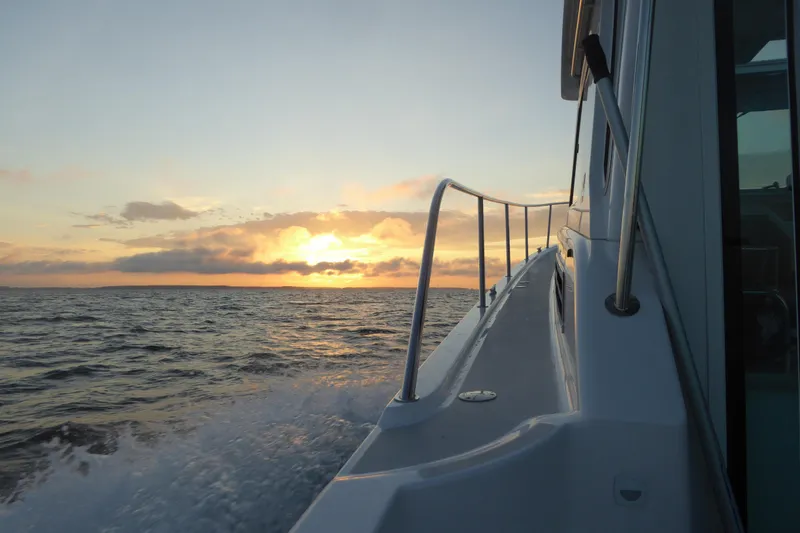 Slide: The Image of Back Cove 37 boat cruising at sunset, 2015 model, ocean view. - 98