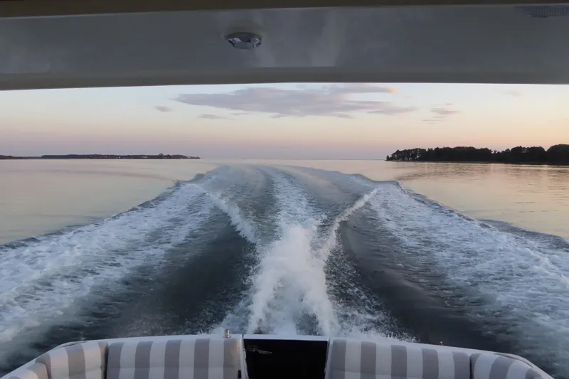 Slide: The Image of Back Cove 37 boat cruising on calm waters at sunset, 2015 model. - 99