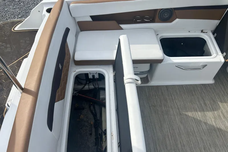 Slide: The Image of 2022 Four Winns HD2 OB boat interior with open storage compartments and seating. - 11