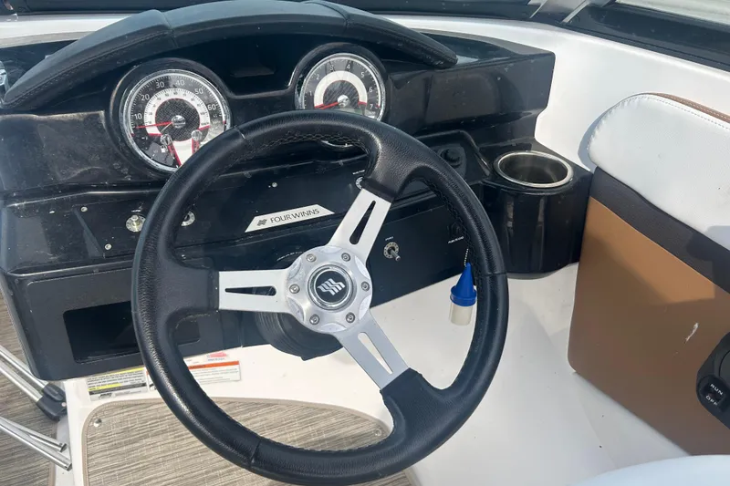 Slide: The Image of Steering wheel and dashboard of 2022 Four Winns HD2 OB boat. - 15