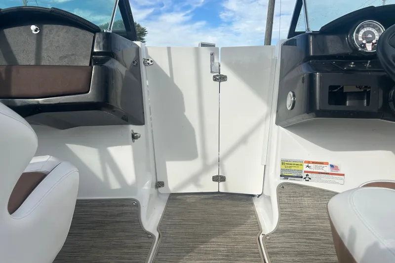 Slide: The Image of Interior view of 2022 Four Winns HD2 OB boat, featuring dashboard and seating. - 17