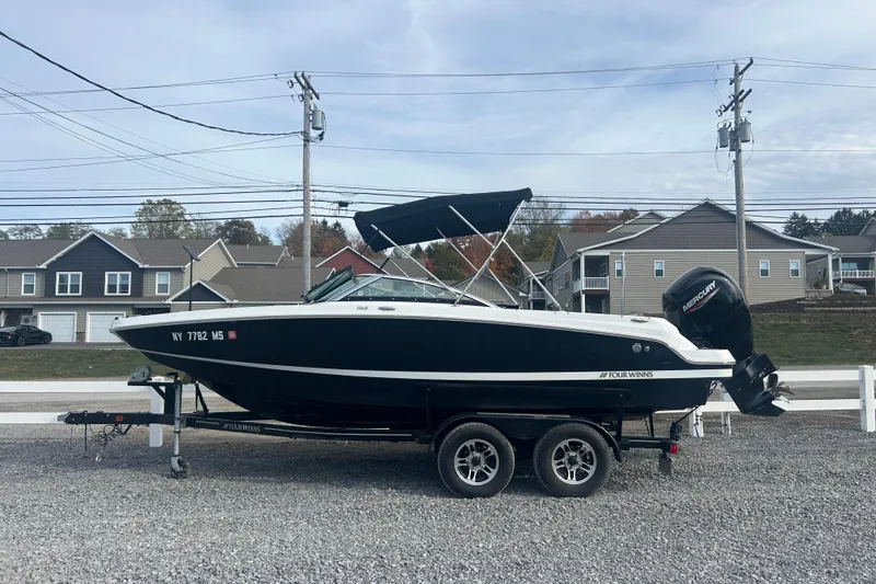 Slide: The Image of 2022 Four Winns HD2 OB boat on trailer, parked outdoors. - 25