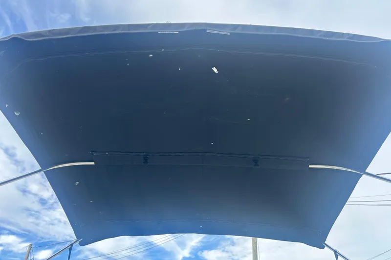 Slide: The Image of Bimini top of 2022 Four Winns HD2 OB boat against a blue sky. - 27