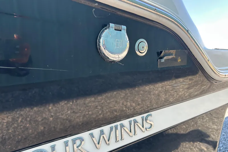 Slide: The Image of 2022 Four Winns HD2 OB boat exterior with logo and hardware details. - 28