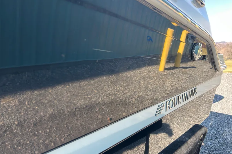 Slide: The Image of 2022 Four Winns HD2 OB boat side view with reflective surface and logo. - 29